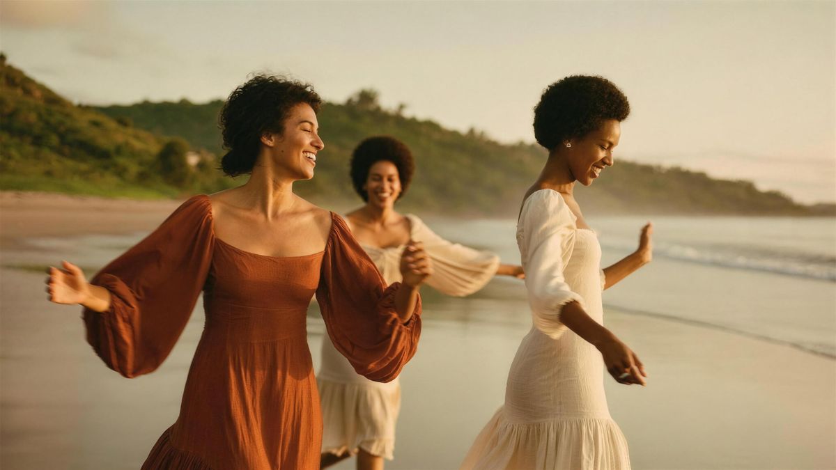 Three women dancing barefoot on a Costa Rican beach at sunset