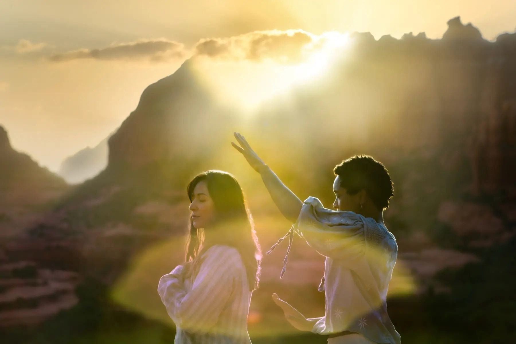 Yolessa giving an intuitive reading to a client on the red rocks at sunset
